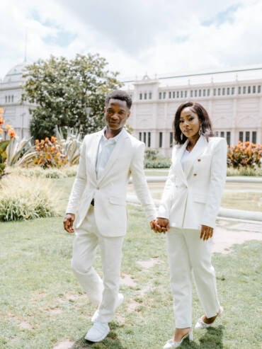 Pre-wedding photos in matching white suits at Carlton Gardens, Melbourne