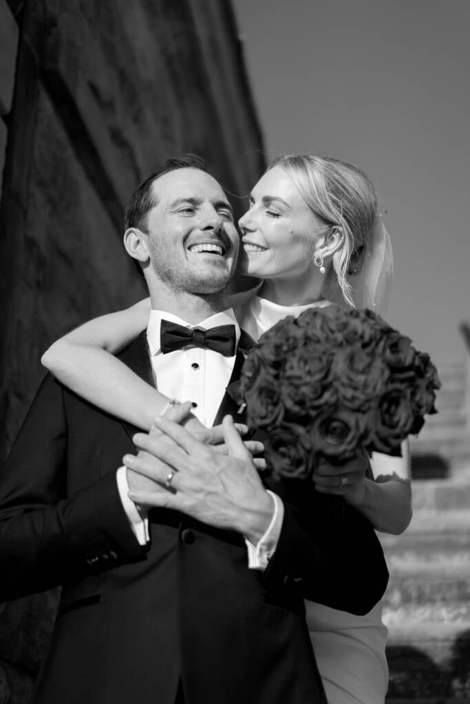 Laughing together on the steps with a dark rose bouquet at Sergeants Mess, Mosman
