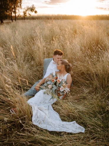 A forehead kiss in the long grass at sunset — Victorian country wedding