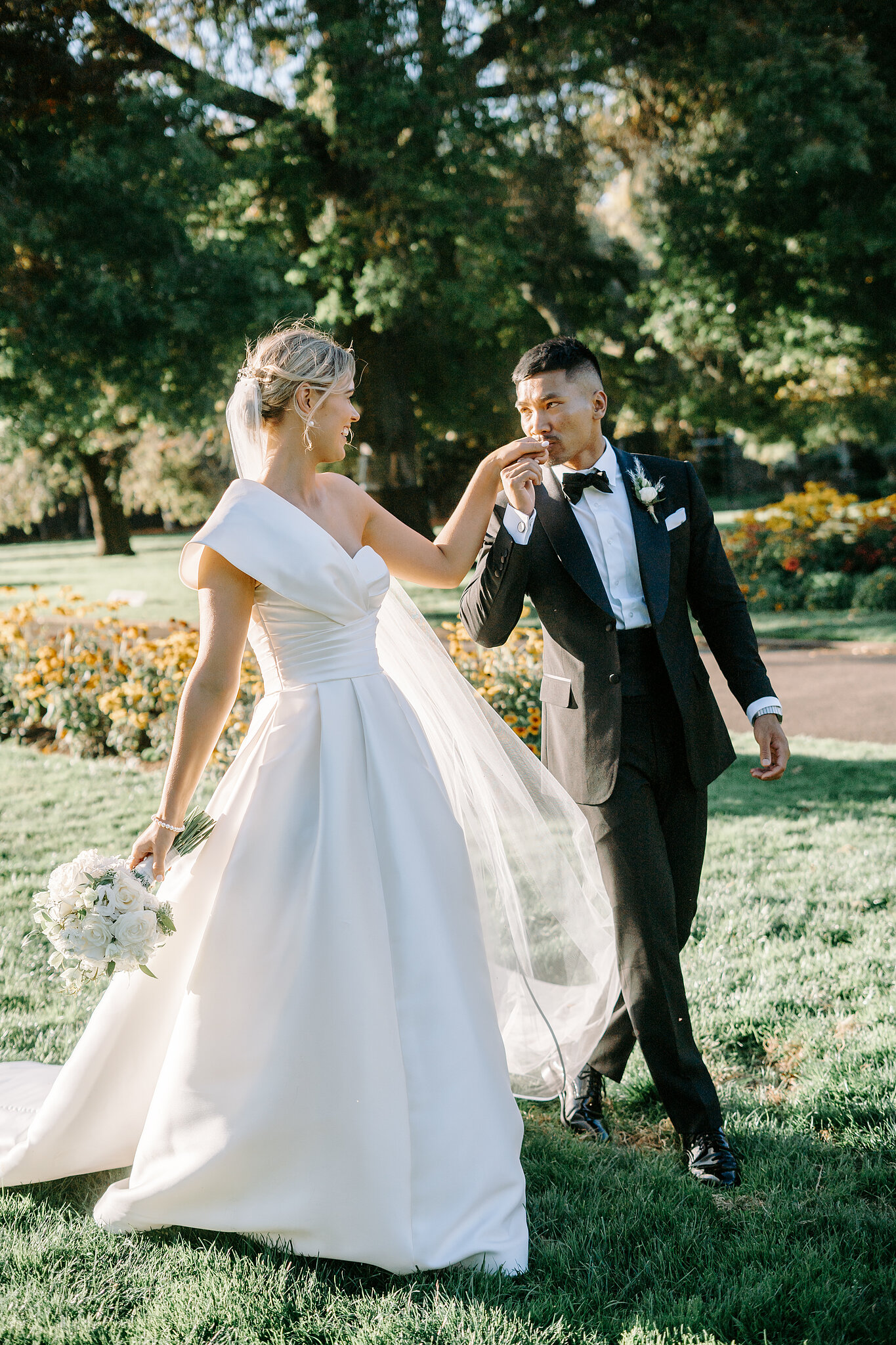 Johnny kisses Georgie’s hand as they walk beneath the old trees at Ballarat Botanical Gardens.