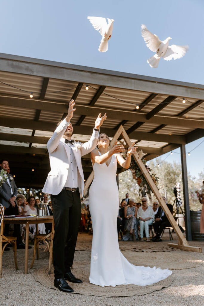 Releasing two white doves at the ceremony under the pavilion at Barn & Co, Balnarring