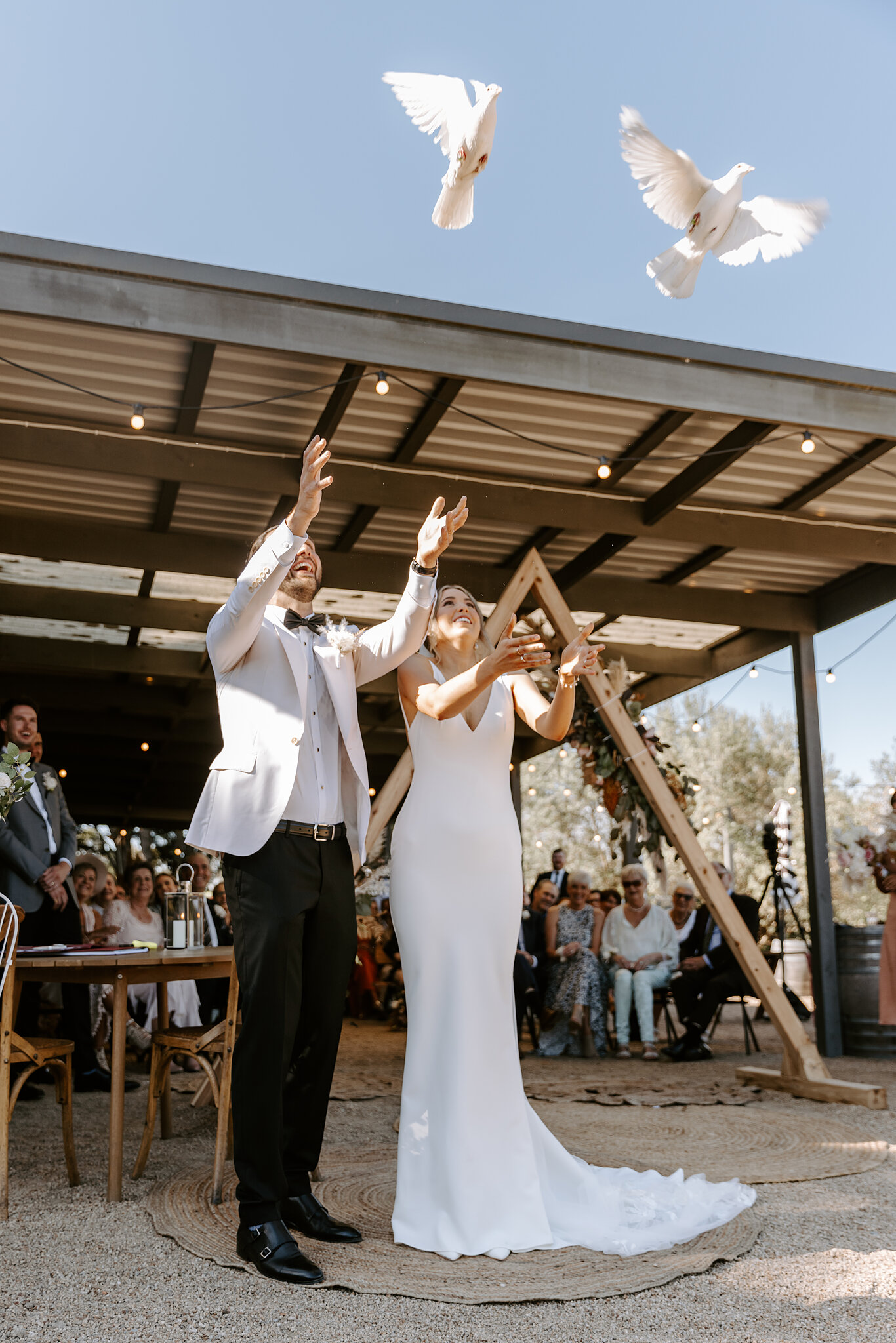 Releasing two white doves at the ceremony under the pavilion at Barn & Co, Balnarring