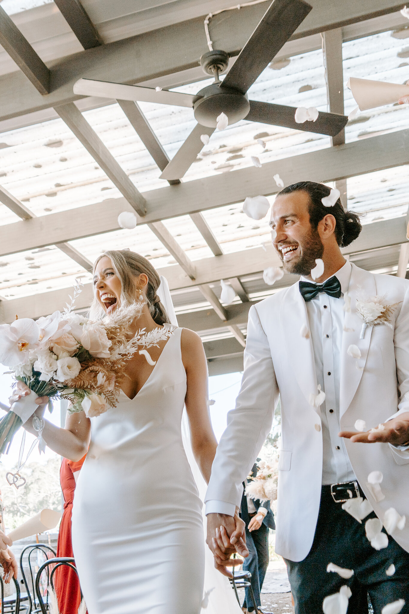 A petal toss as they walk out under the pergola at Barn & Co, Balnarring