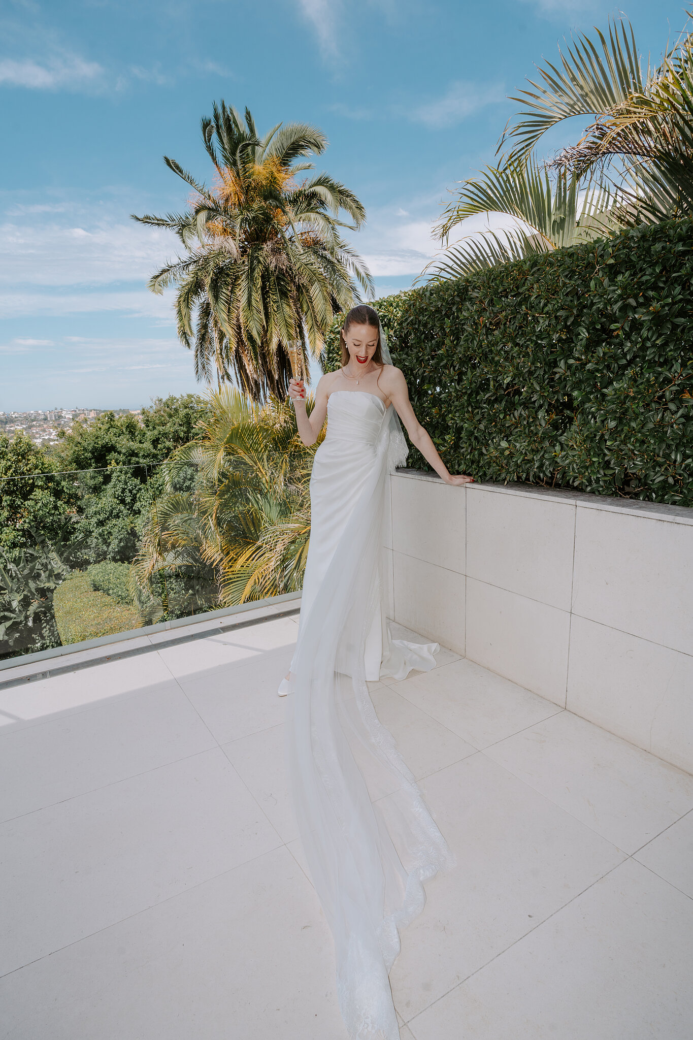 Michele on the terrace in Bellevue Hill, her long veil trailing across the tiles under the palms.