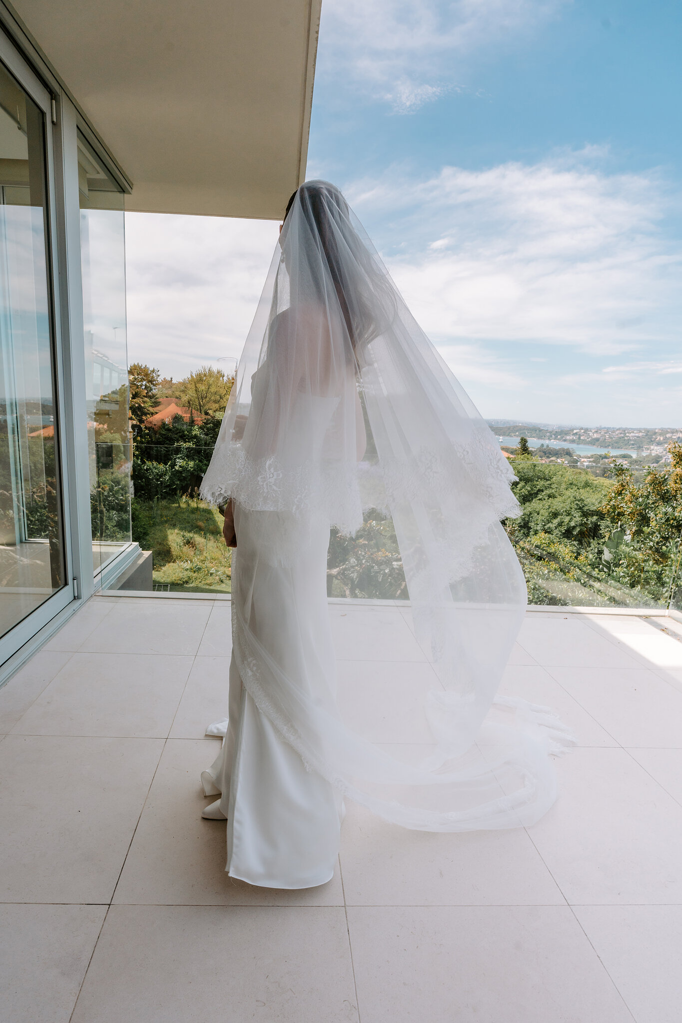Michele’s long veil lifts in the breeze as she looks out over the water from the terrace.
