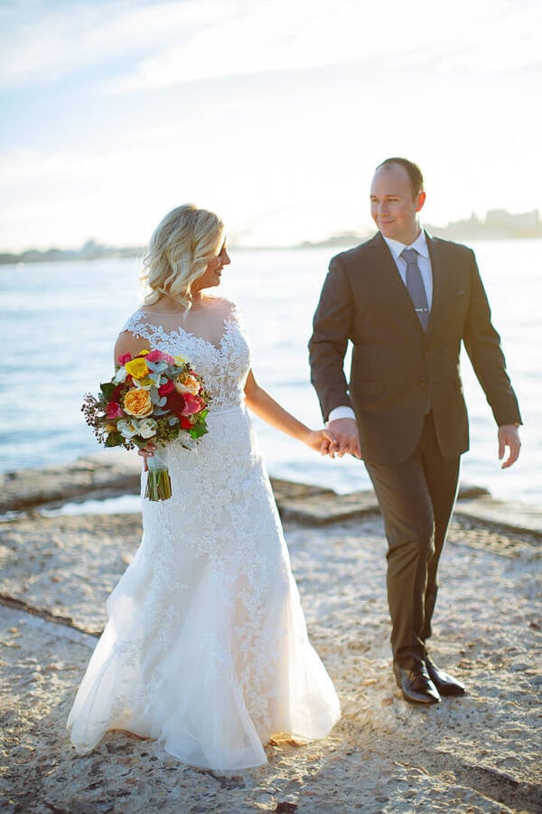 Sabine and Arthur walking beside Sydney Harbour at Bradleys Head Bradleys Head Wedding Photo Sydney North Shore