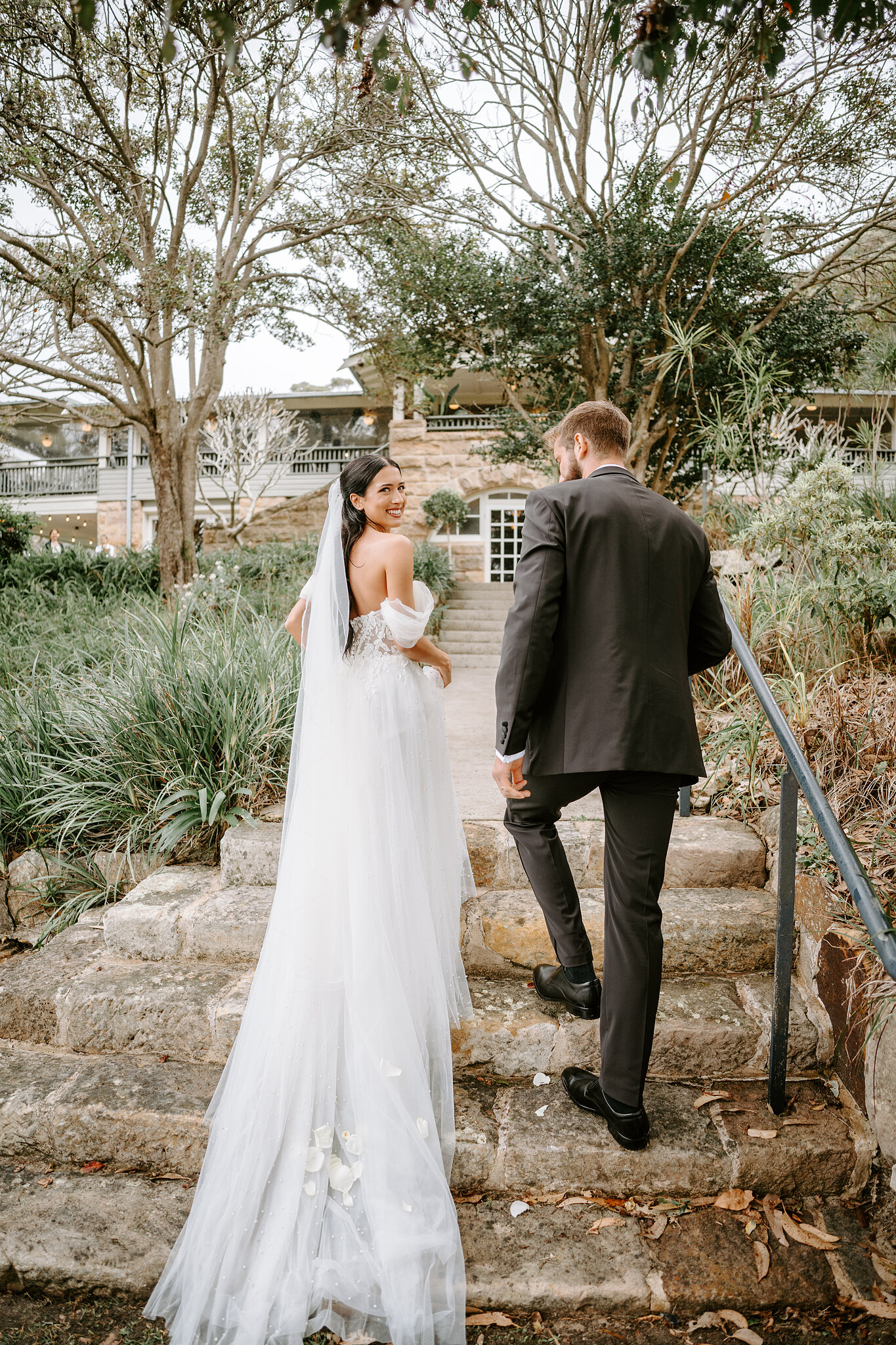 Alexa glances back as Chris leads her up the sandstone steps to Burnt Orange.