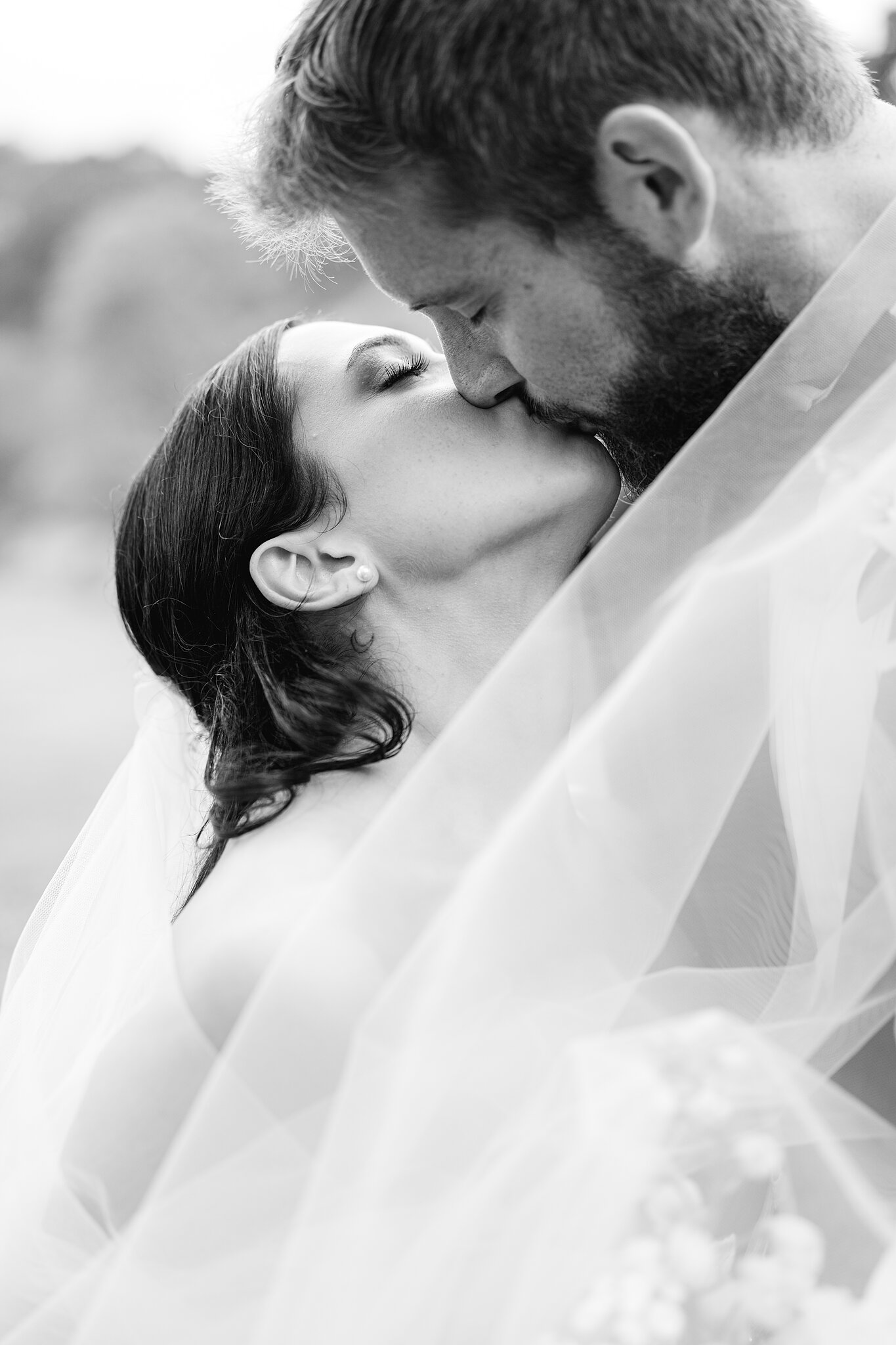 Alexa and Chris kiss, wrapped together in her veil.