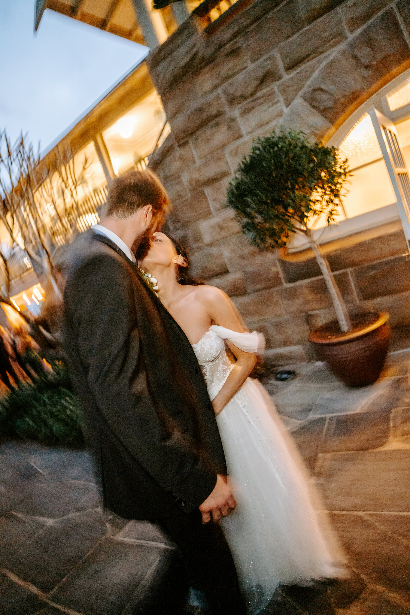 An after-dark kiss against the glowing sandstone walls of Burnt Orange.