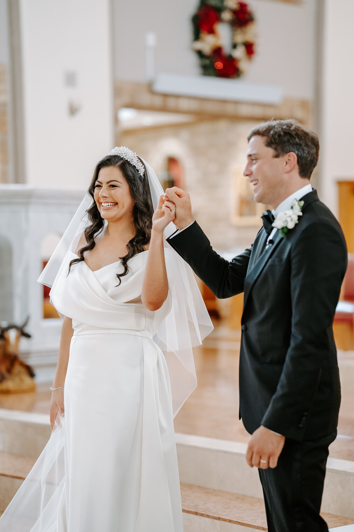 Helena and Xavier raise their joined hands inside St Christopher’s in Forrest.