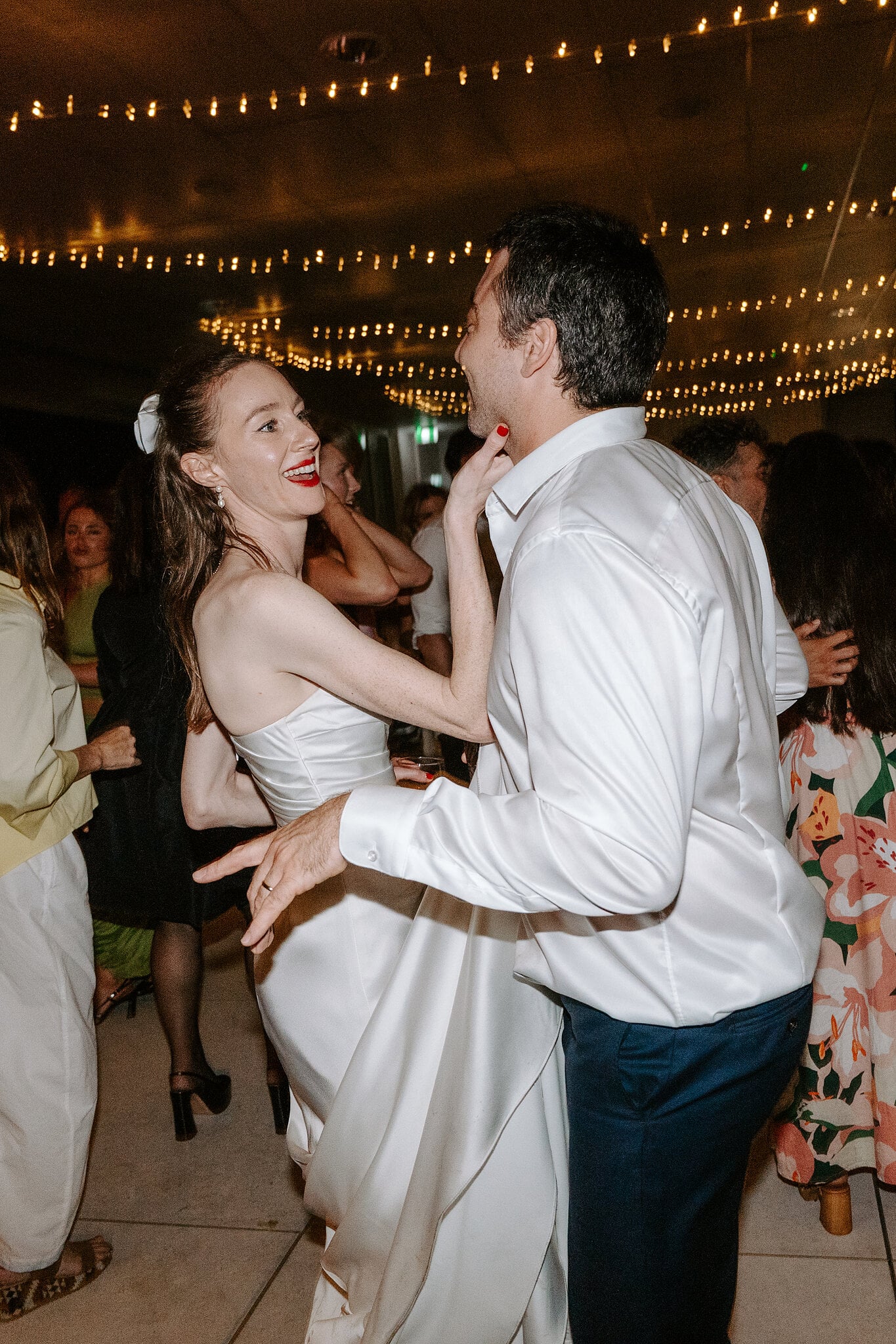 Michele and Nico dancing under the fairy-light canopy at Horizons South Maroubra.