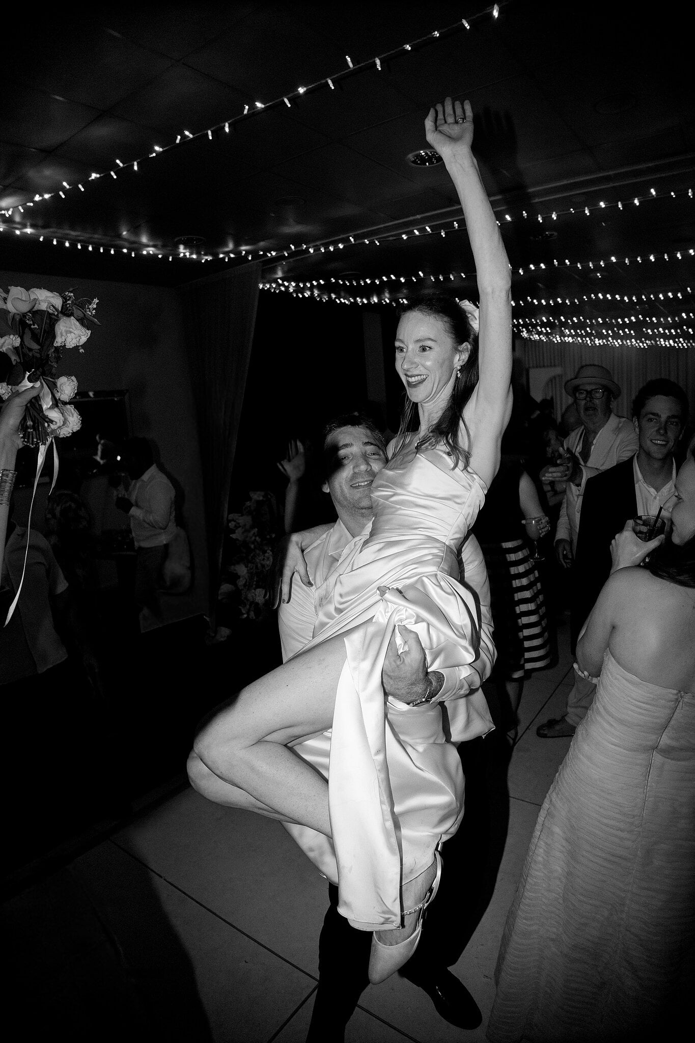 Michele kicks up her heel and throws an arm in the air on the dance floor at Horizons.
