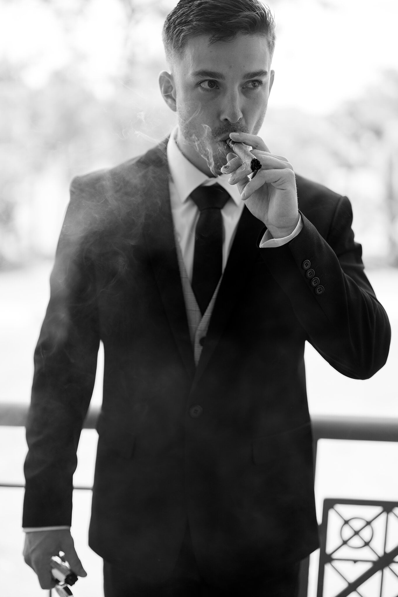 Lane enjoys a celebratory cigar on the balcony before the ceremony.