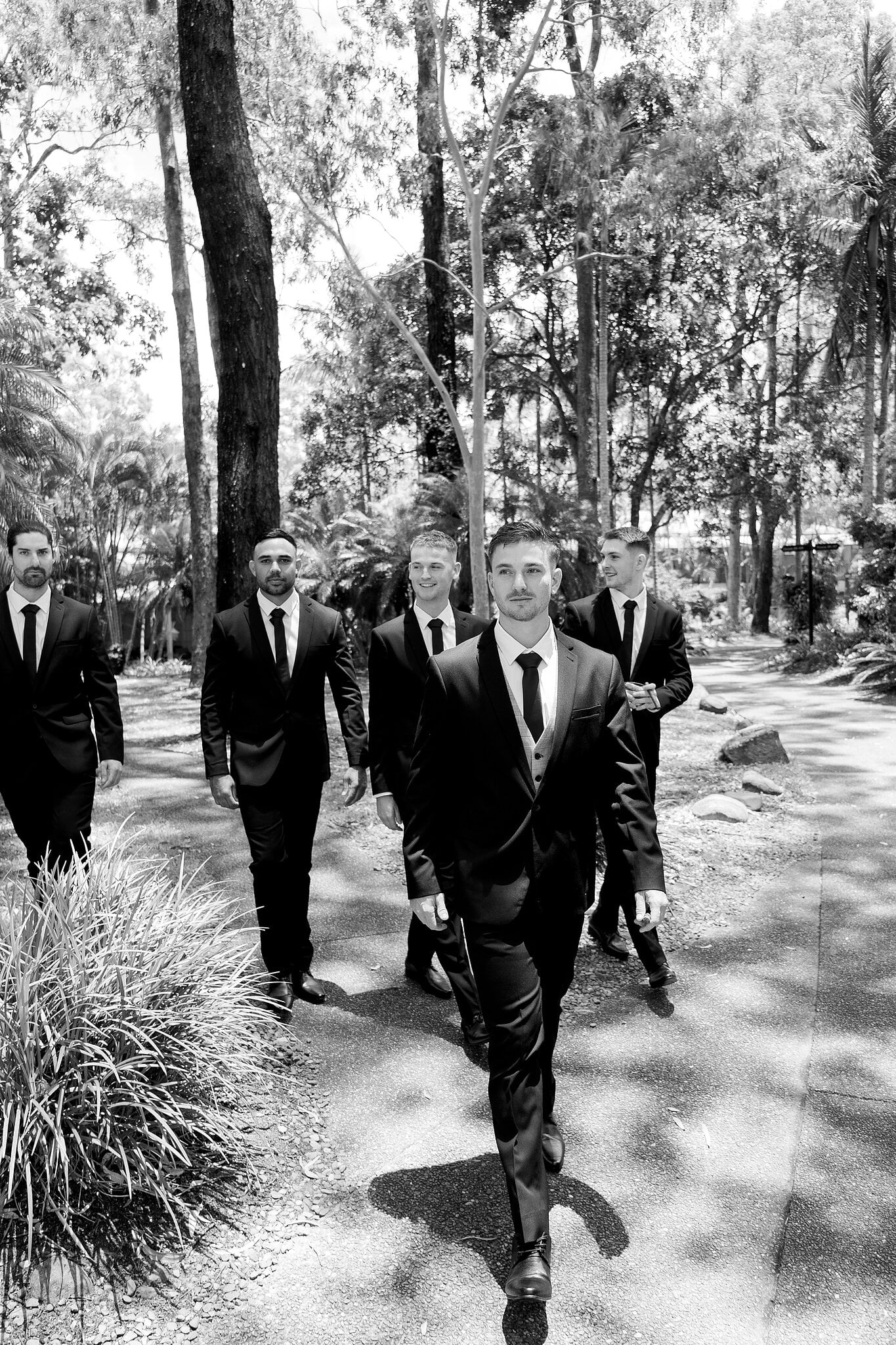 Lane and his groomsmen stride through the tropical gardens at InterContinental Sanctuary Cove.