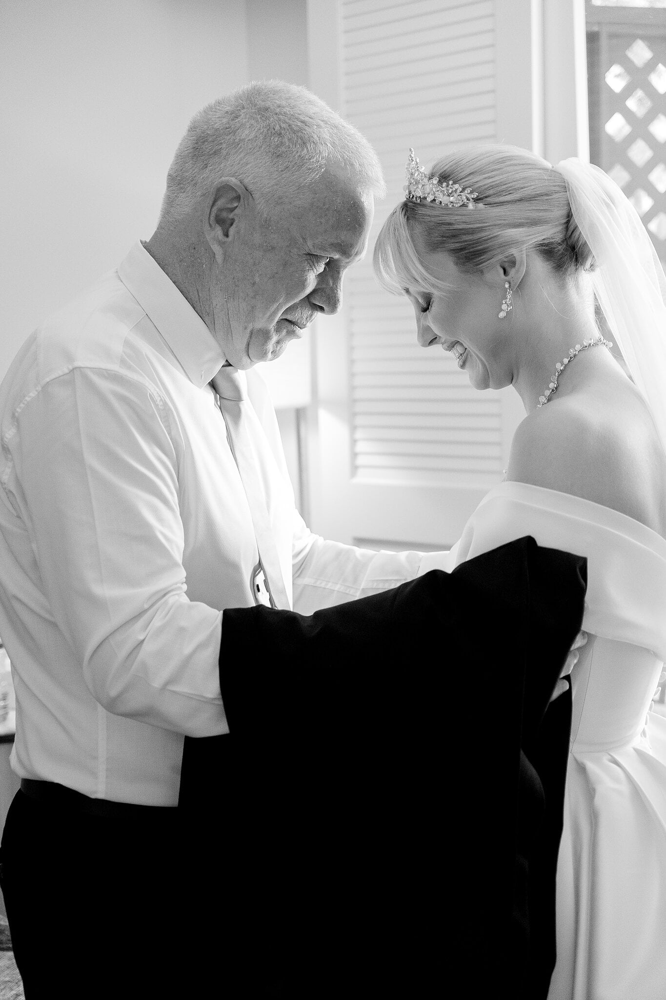 Ashley shares a quiet, head-bowed moment with her dad before the ceremony.