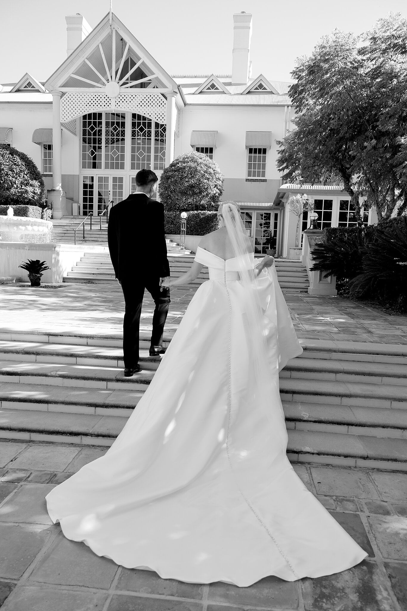 Lane leads Ashley up the sandstone steps towards the main house.
