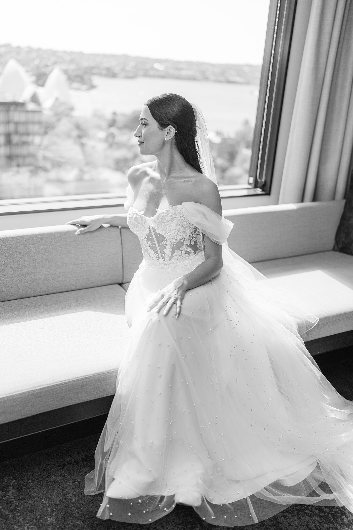 Alexa by the window at InterContinental Sydney, the Sydney Opera House sails over her shoulder.