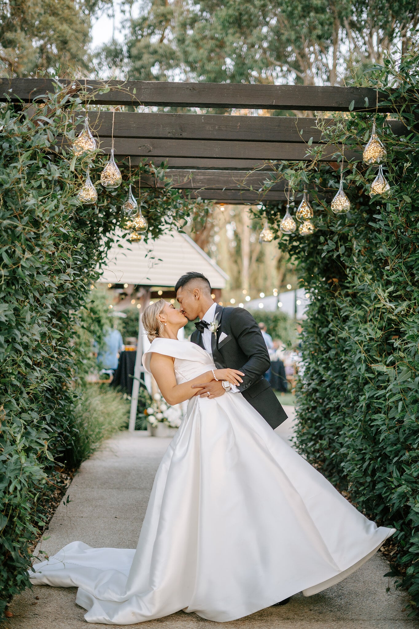 Johnny dips Georgie for a kiss under the pergola lights at Mercure Ballarat.
