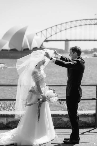 Lifting the veil with the Opera House and Harbour Bridge behind — Ovolo Woolloomooloo wedding
