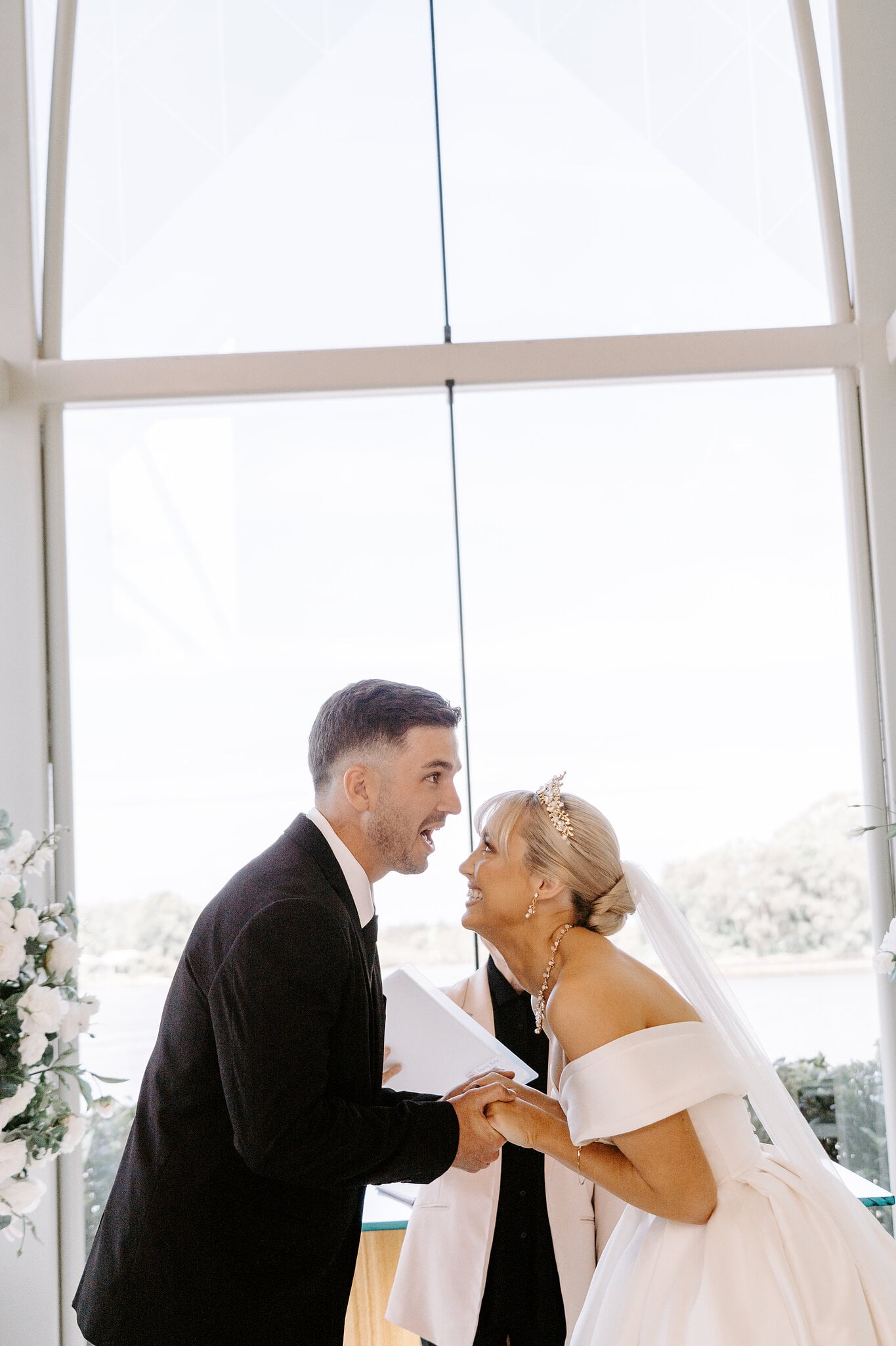 Ashley and Lane lean in, grinning, moments before their first kiss.