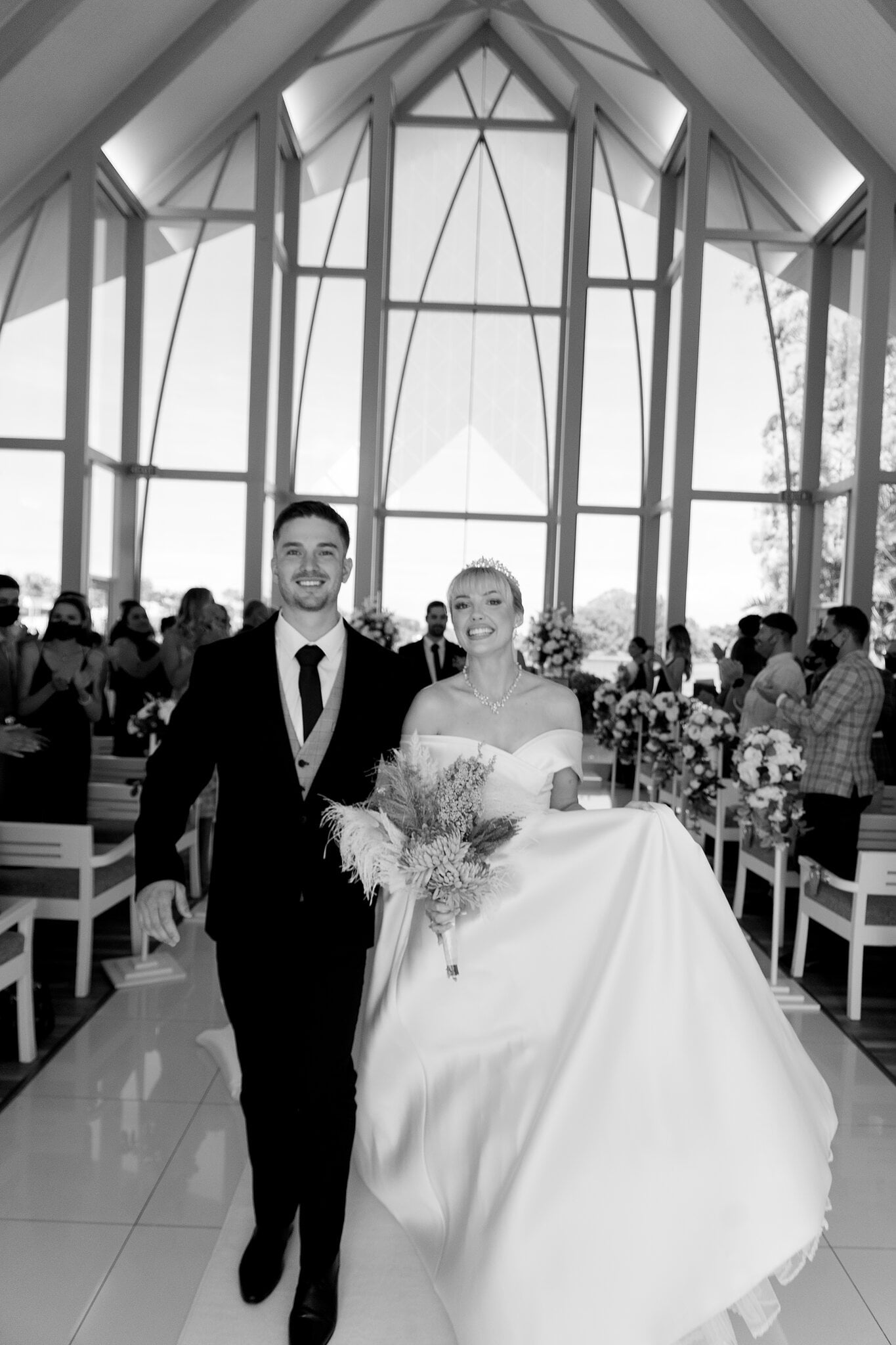 Ashley and Lane laugh their way back down the aisle as a married couple.