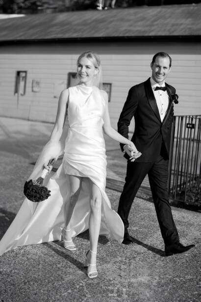 Hand in hand past the weatherboard wall at Sergeants Mess, Mosman