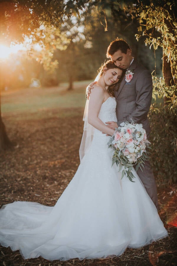 Shannon and Luke embrace beneath the trees at Sunnybrae Estate Sunnybrae Estate Wedding Photo Adelaide