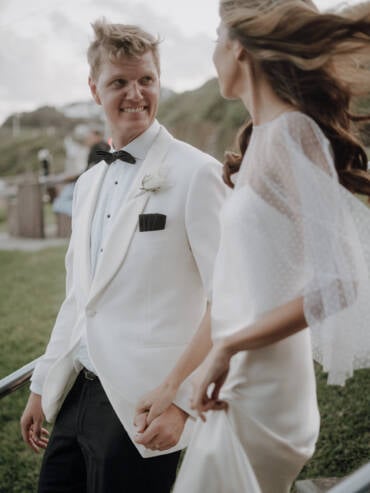 Hand in hand up the steps, his white dinner jacket and her windswept hair — Merewether Surfhouse, Newcastle
