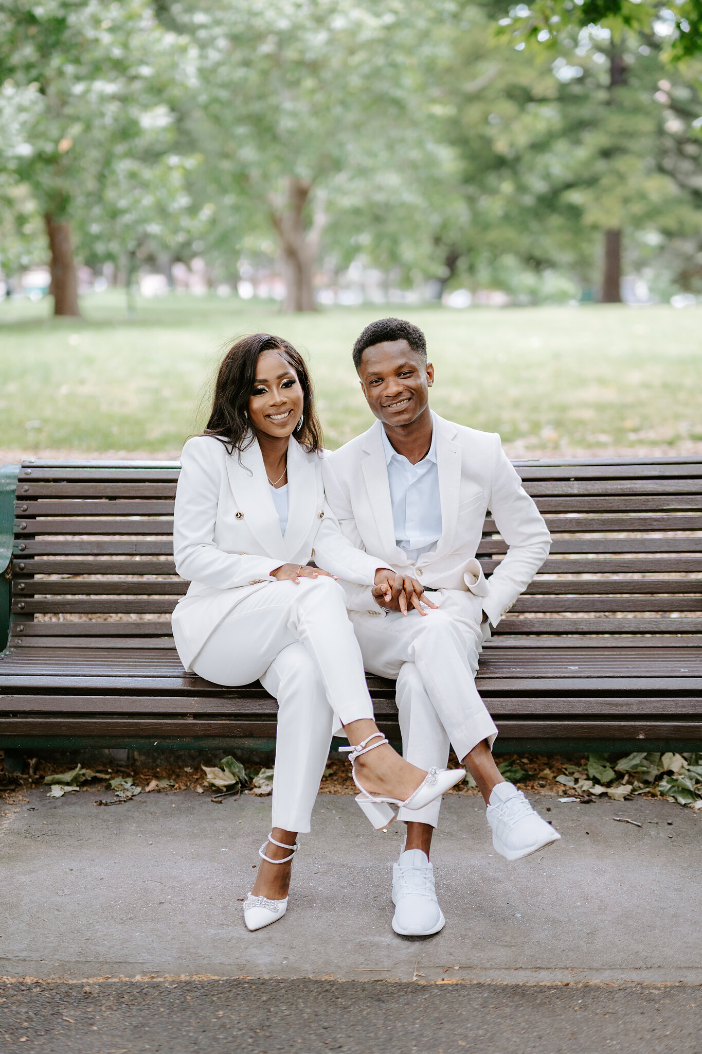 Pearl and Allen share a smile on a timber park bench in Carlton Gardens.