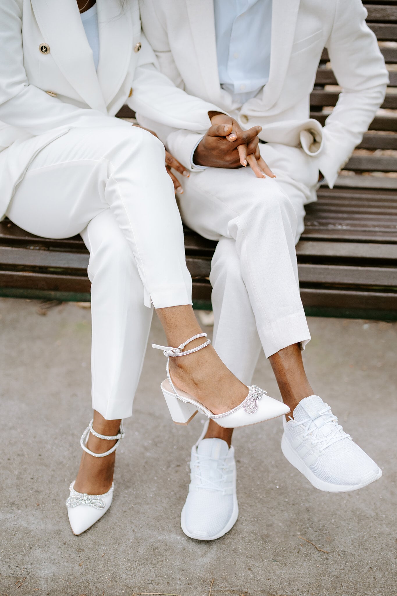 Pearl’s crystal-trimmed heels and Allen’s white sneakers, legs crossed side by side on the bench.