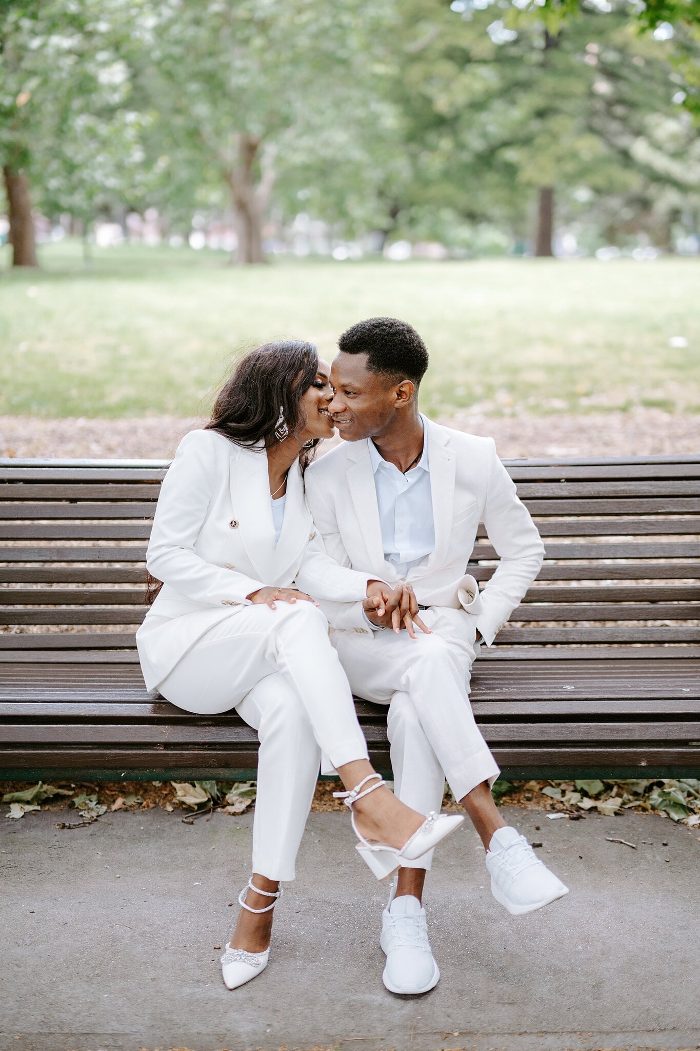 Pearl leans in to kiss Allen’s cheek on a park bench in Carlton Gardens.
