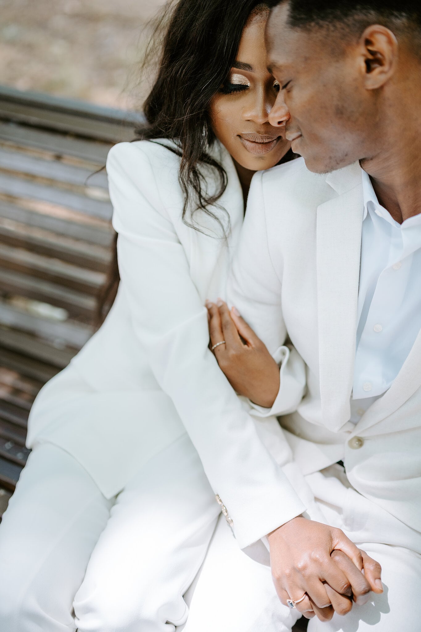 Pearl rests against Allen’s shoulder on the bench, holding his hand, her engagement ring on show.