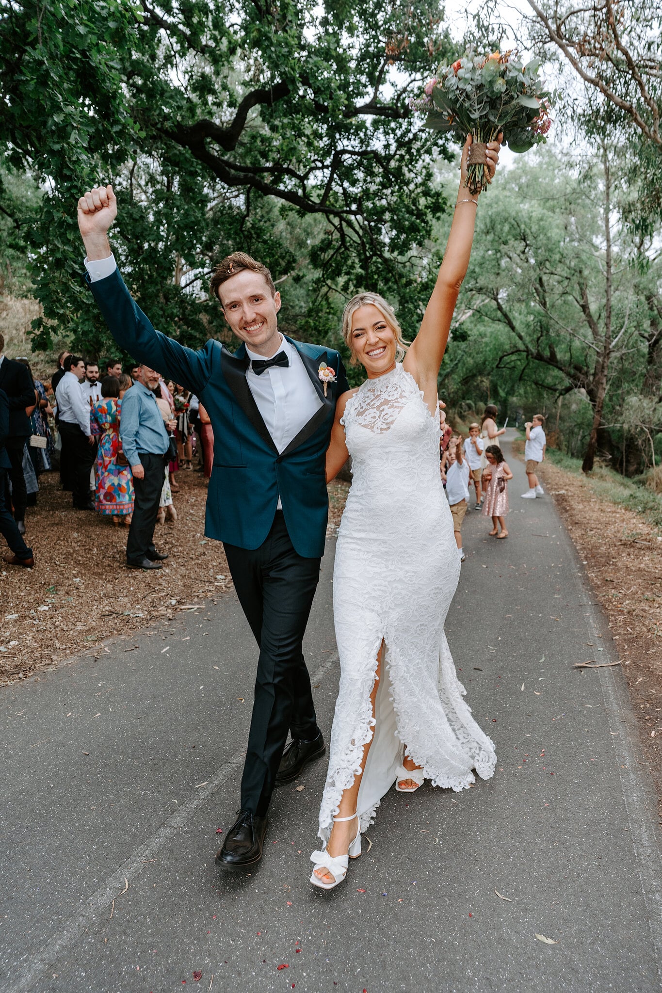Emma and George throw their arms in the air as they walk back up the farm track.