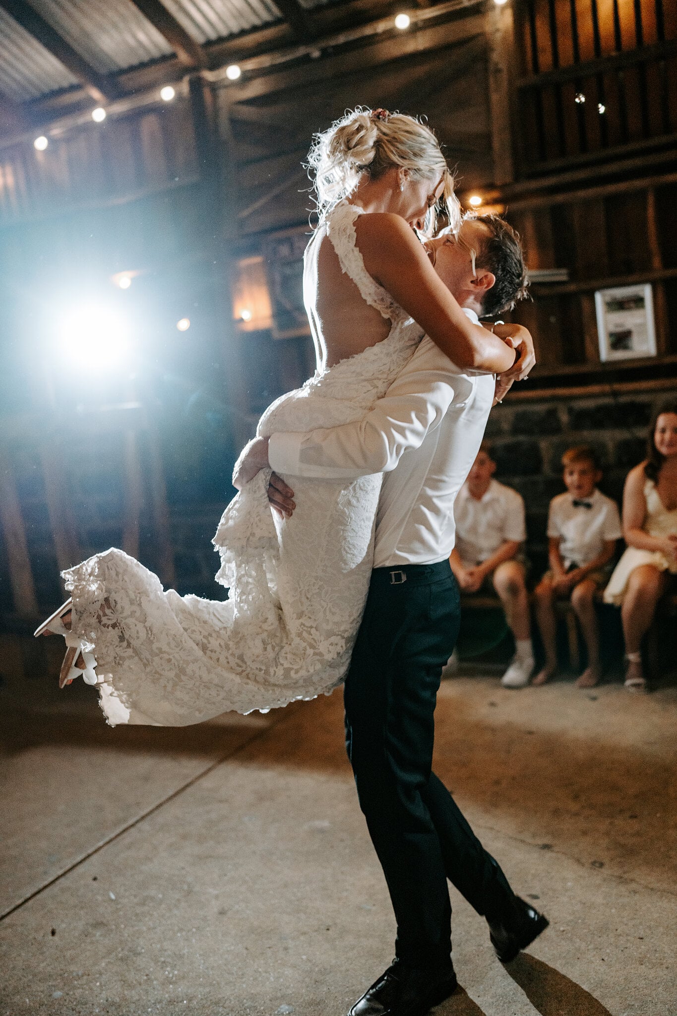 George lifts Emma high on the dance floor, her lace train flying.