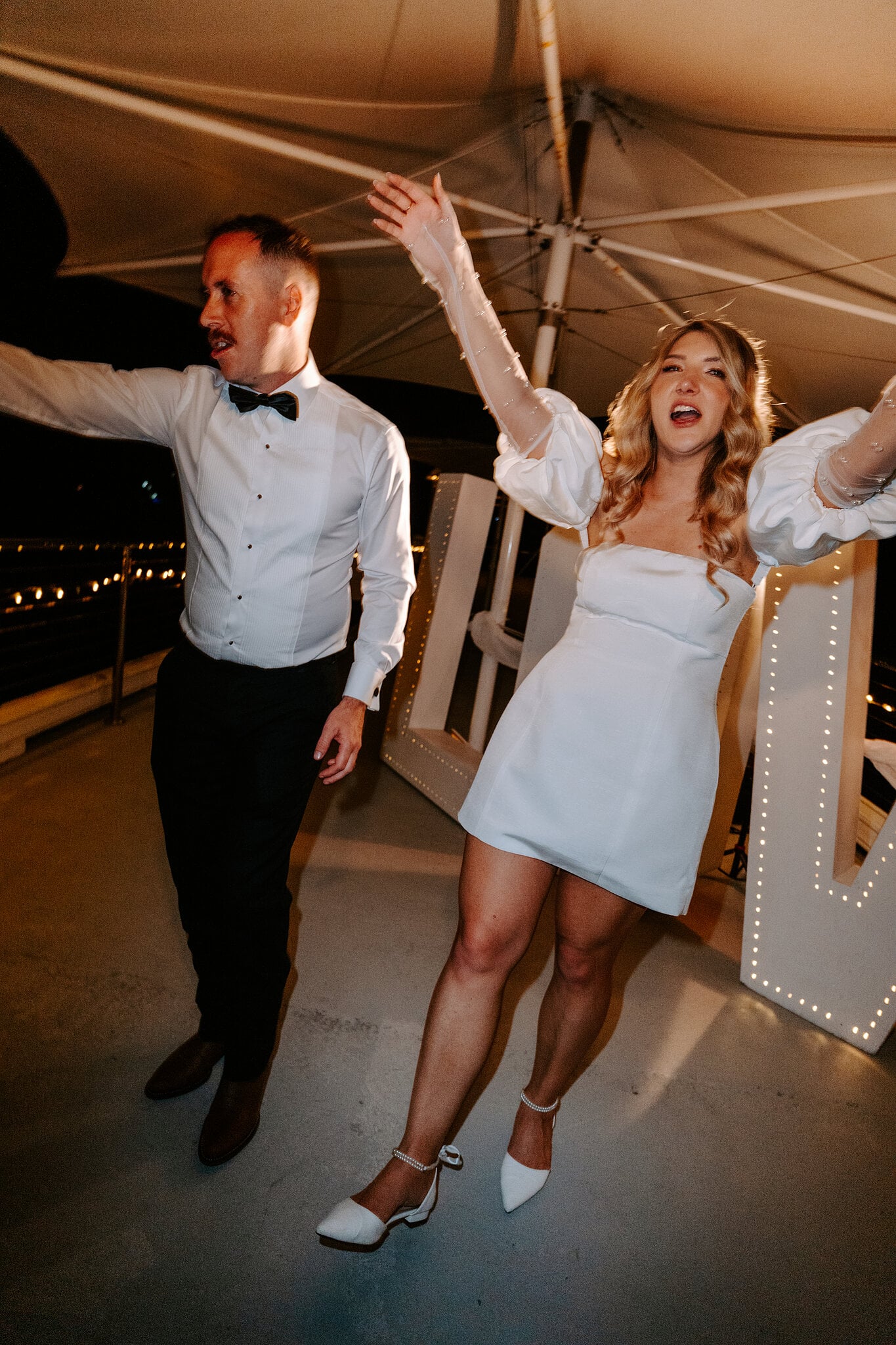 Anna, in her short white second dress, and Brendan hit the dance floor beside light-up LOVE letters.