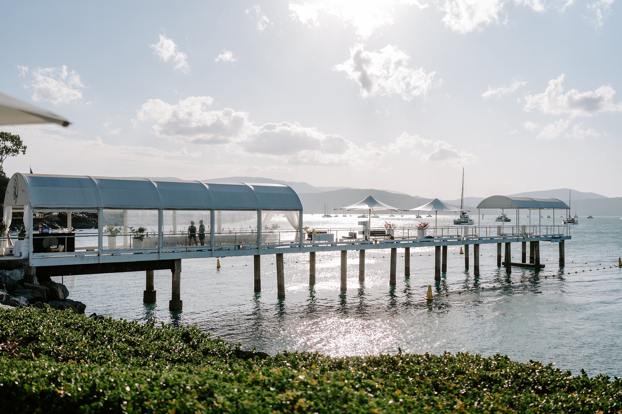 The jetty at Coral Sea Resort stretching out over the water in the afternoon light.