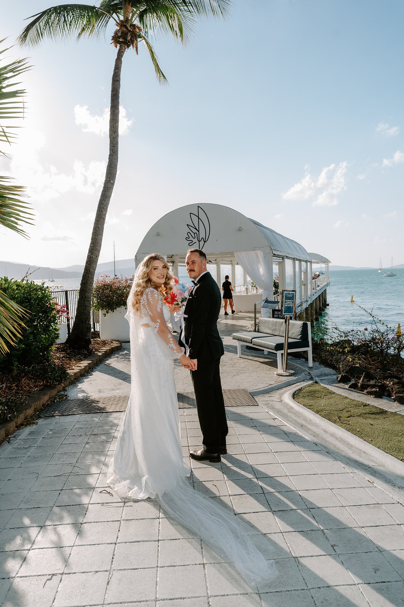 Anna and Brendan at the entrance to the jetty, its white marquee behind them.
