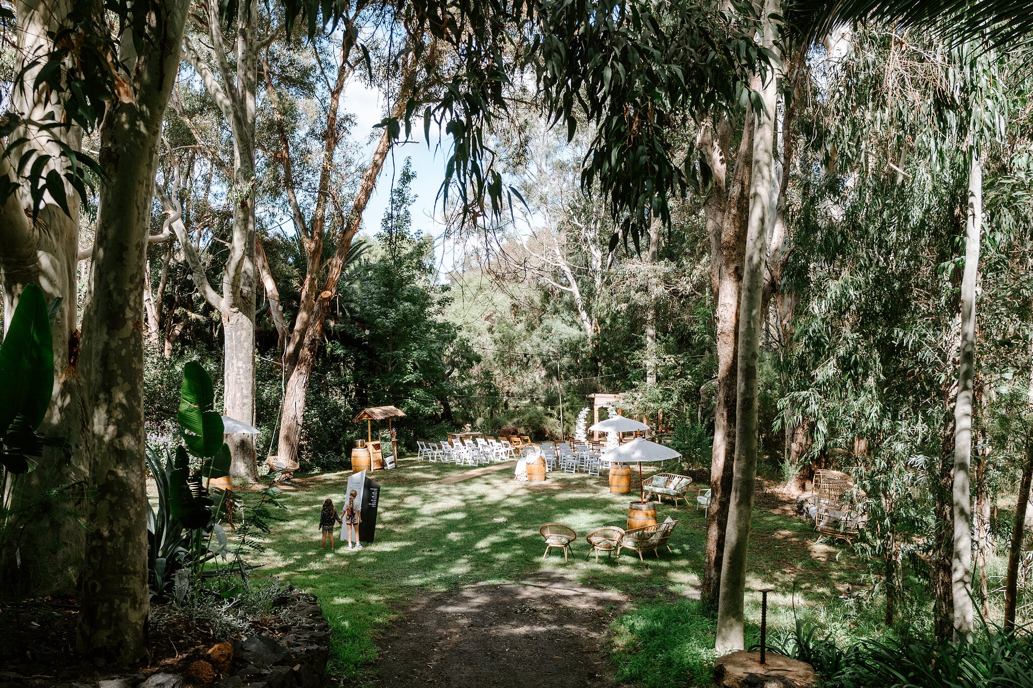 Tall gums and tropical palms frame the garden ceremony lawn at Ferguson Valley Escape.