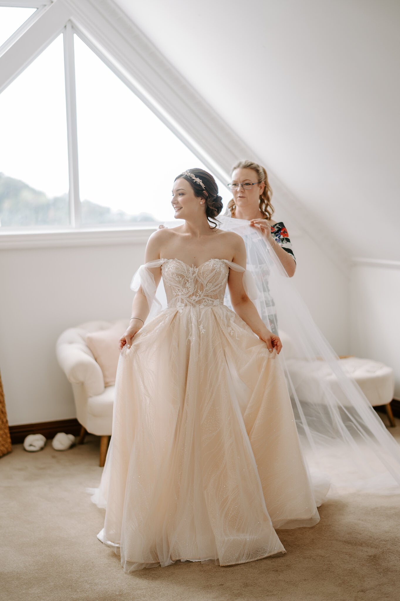 Jamie’s mum lifts her veil behind her as she gathers her blush skirt under the Loft window.