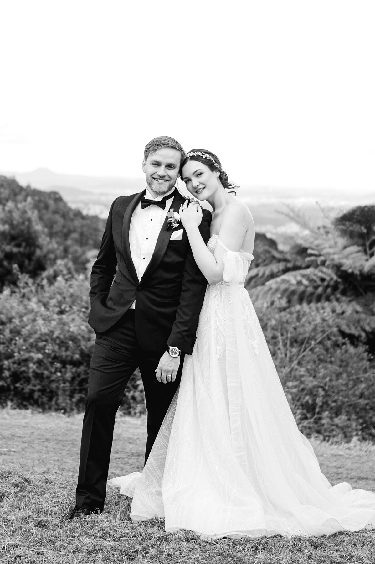 Jamie leans her head on Tim’s shoulder at the top of the Maleny Manor grounds, in black and white.