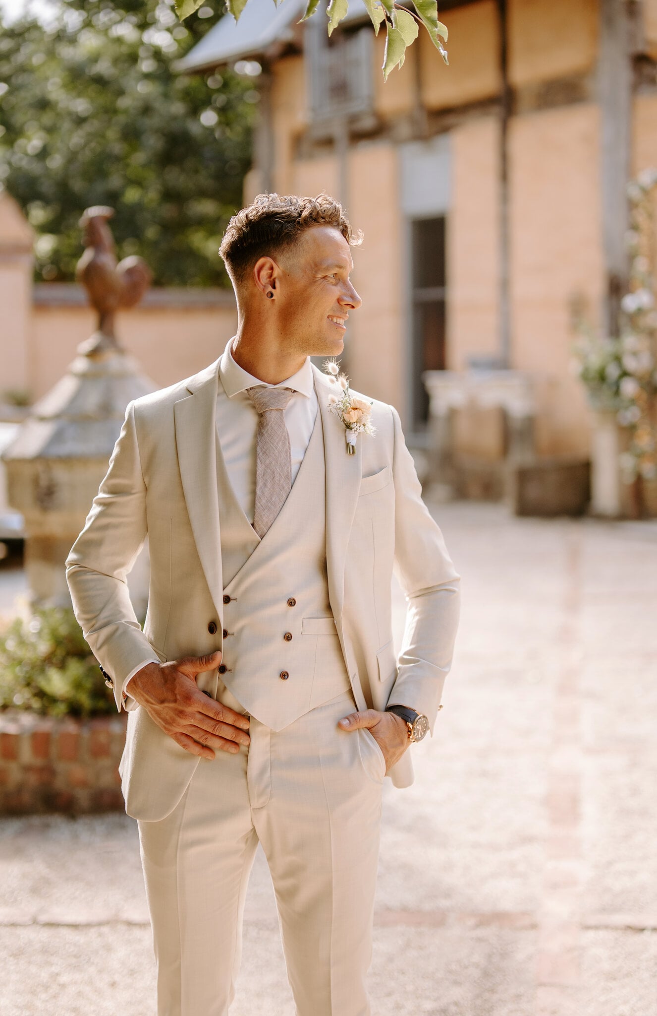 Harrison in his cream three-piece suit in the sunny courtyard at Mont du Soleil.