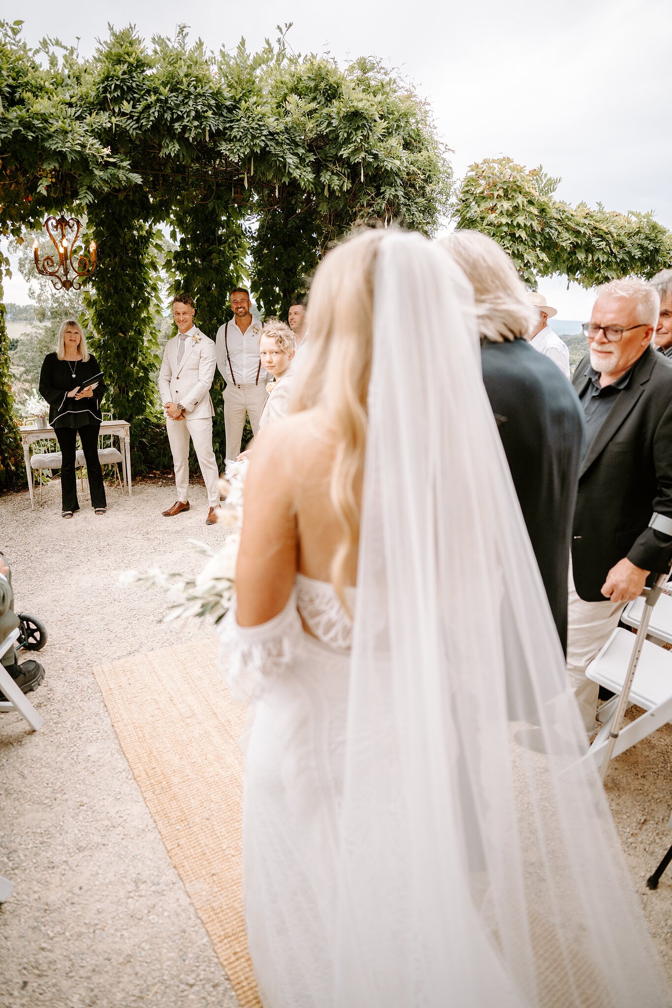 Samantha walks the aisle towards Harrison and the vine-covered arbour at Mont du Soleil.