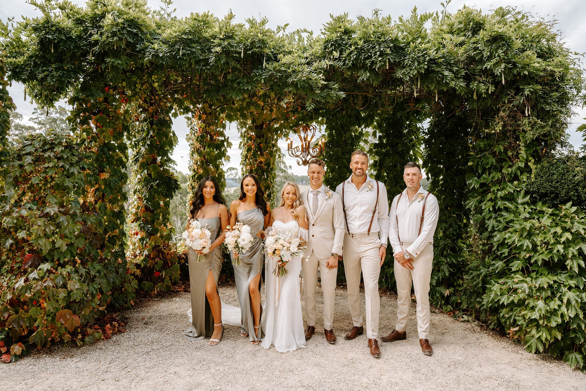 The bridal party lines up under the vine-covered arbour at Mont du Soleil.