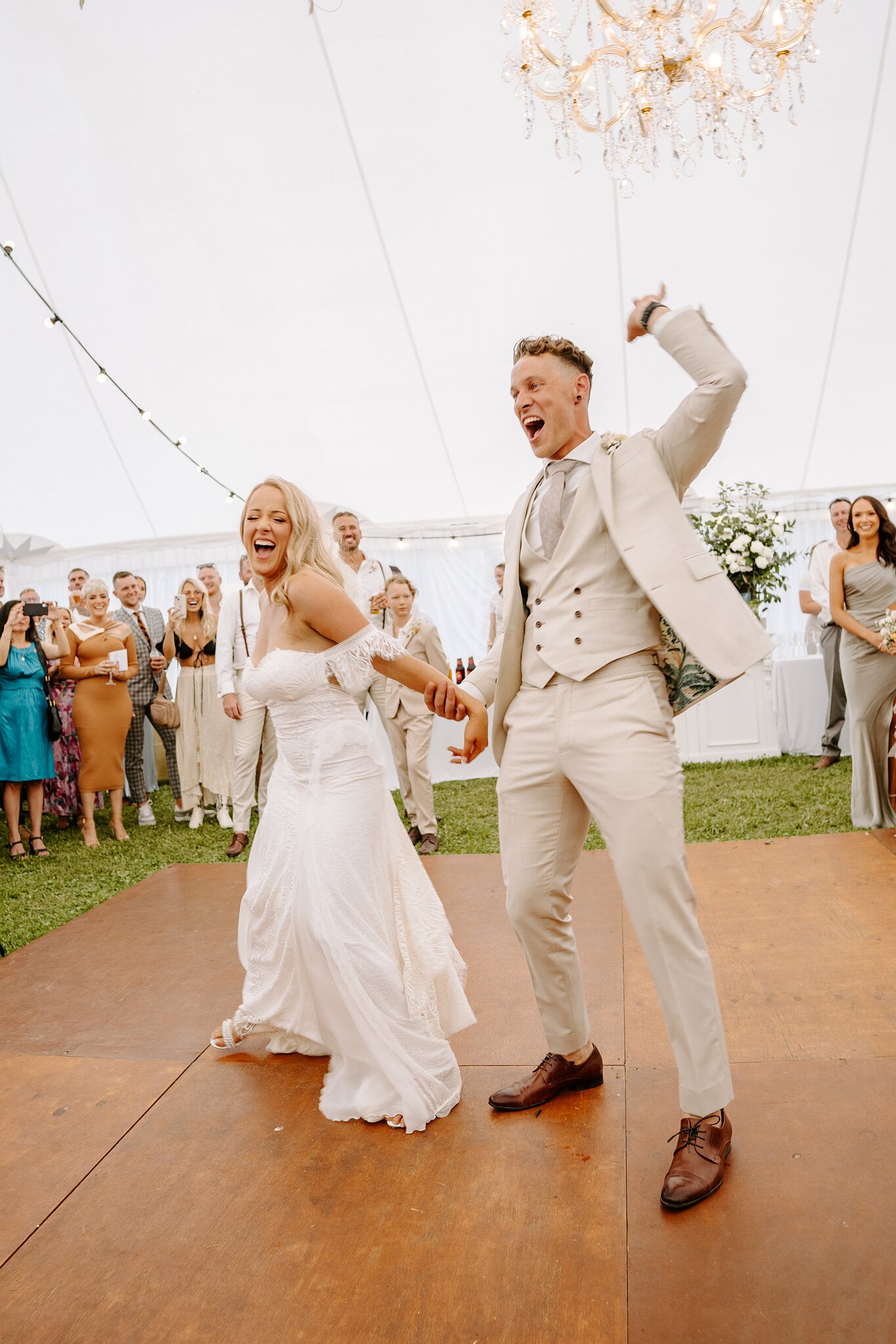 Harrison throws his arm up as he and Samantha dance into their marquee reception.