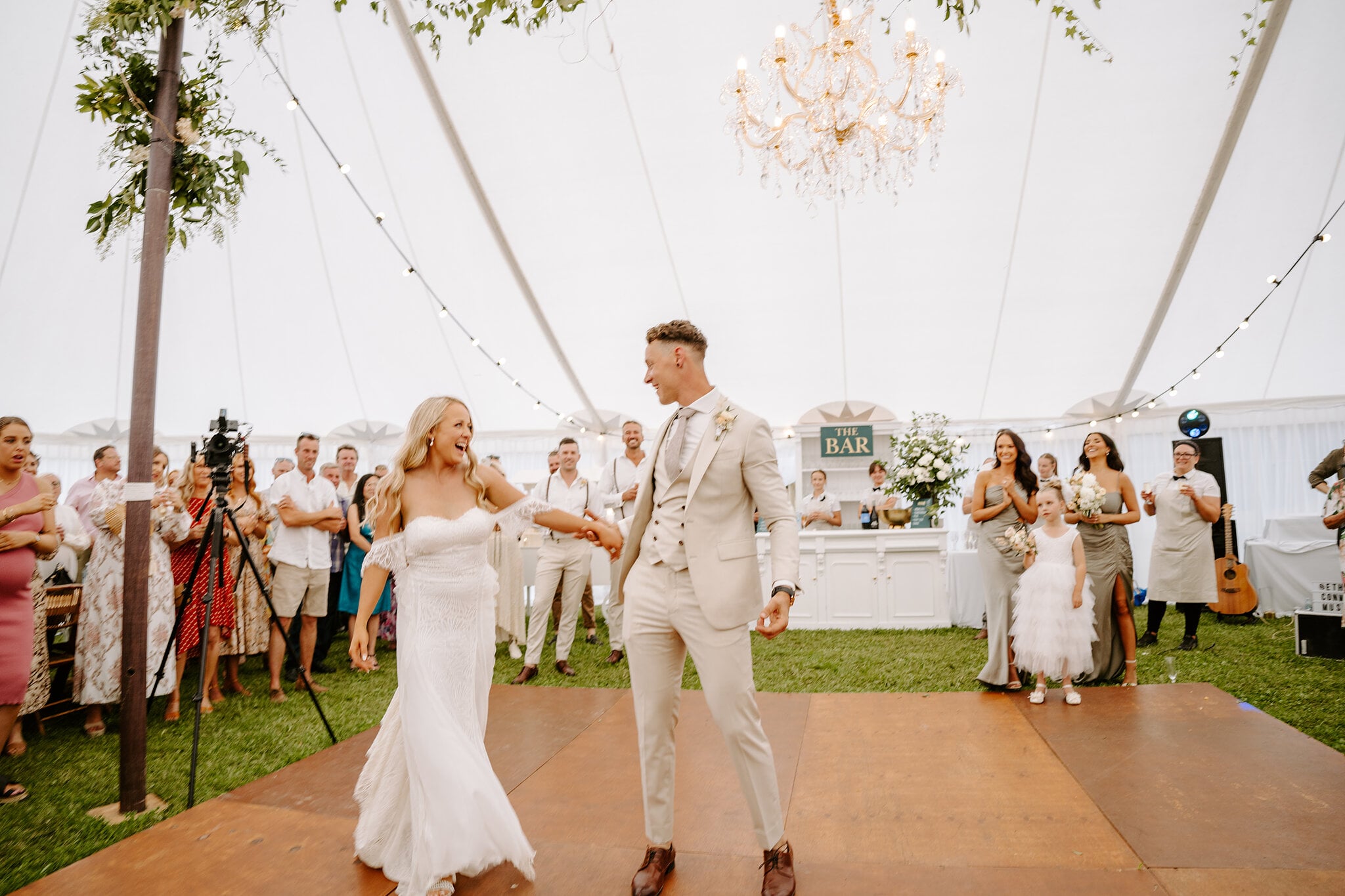 Samantha and Harrison make their grand entrance onto the dance floor as guests cheer.