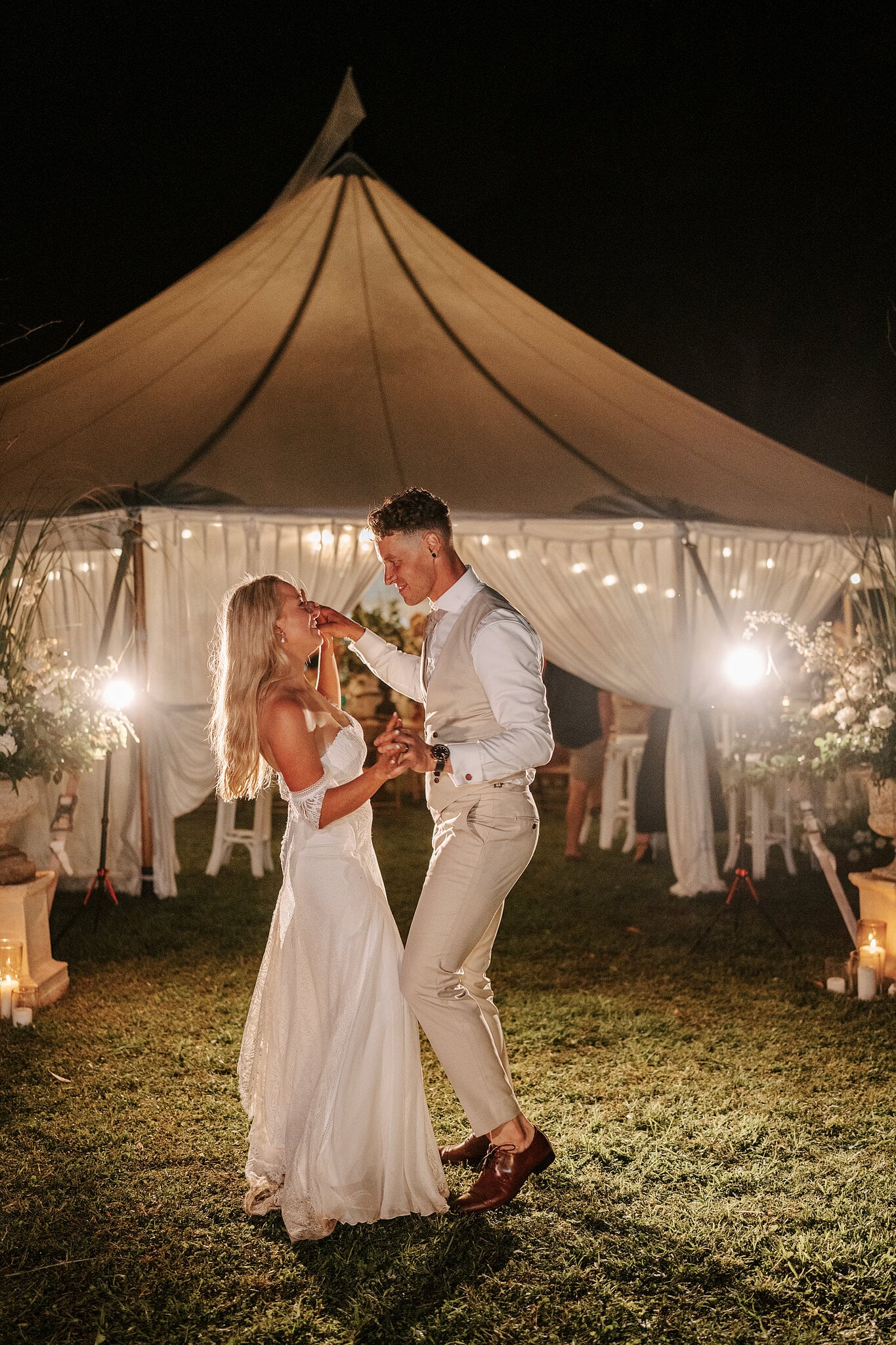 Samantha laughs as Harrison twirls her outside the candlelit marquee.