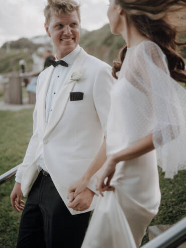 Hand in hand up the steps, his white dinner jacket and her windswept hair — Merewether Surfhouse, Newcastle
