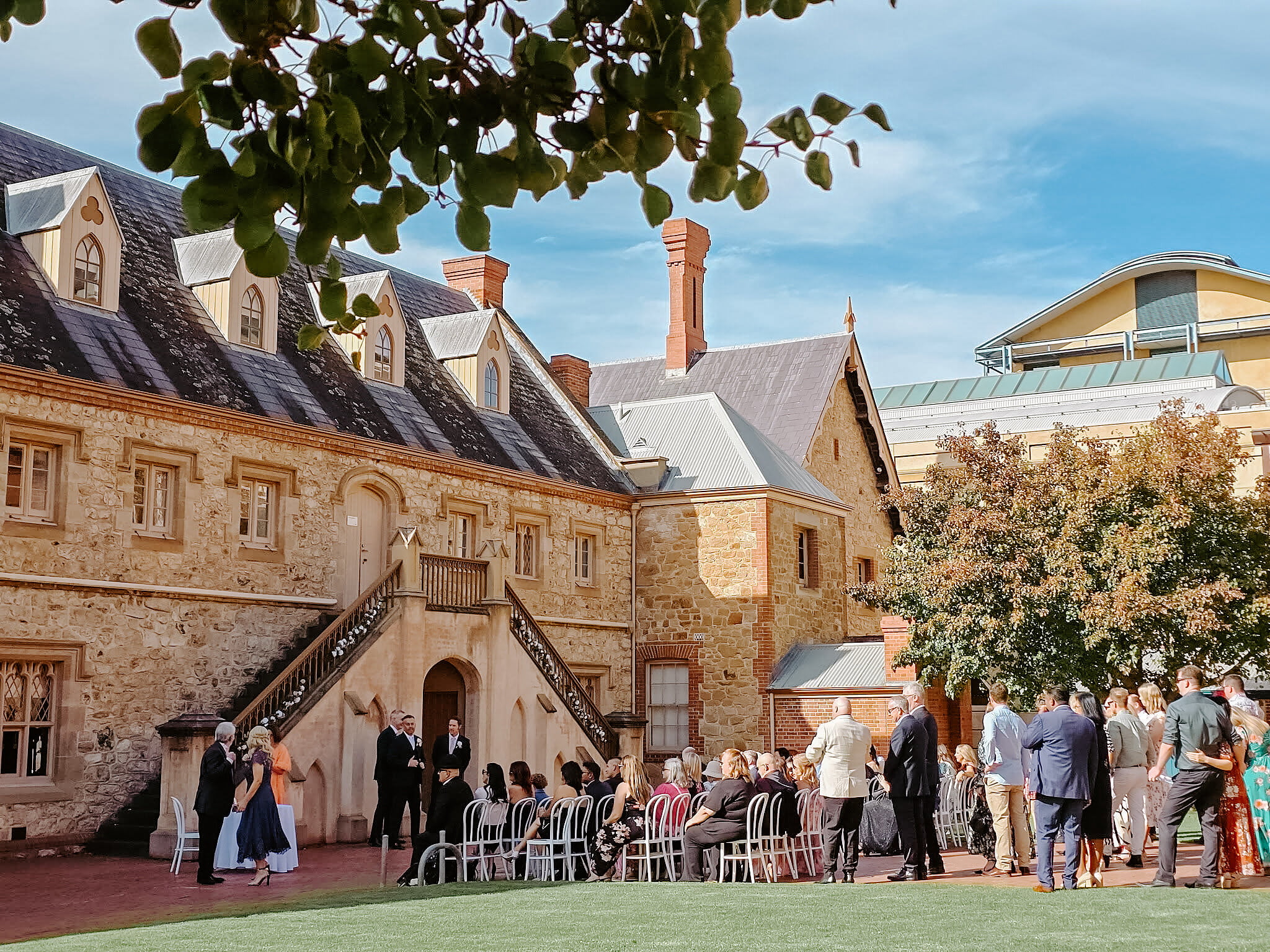 Guests gather beside the Armoury’s sandstone walls and dormer windows before the ceremony.