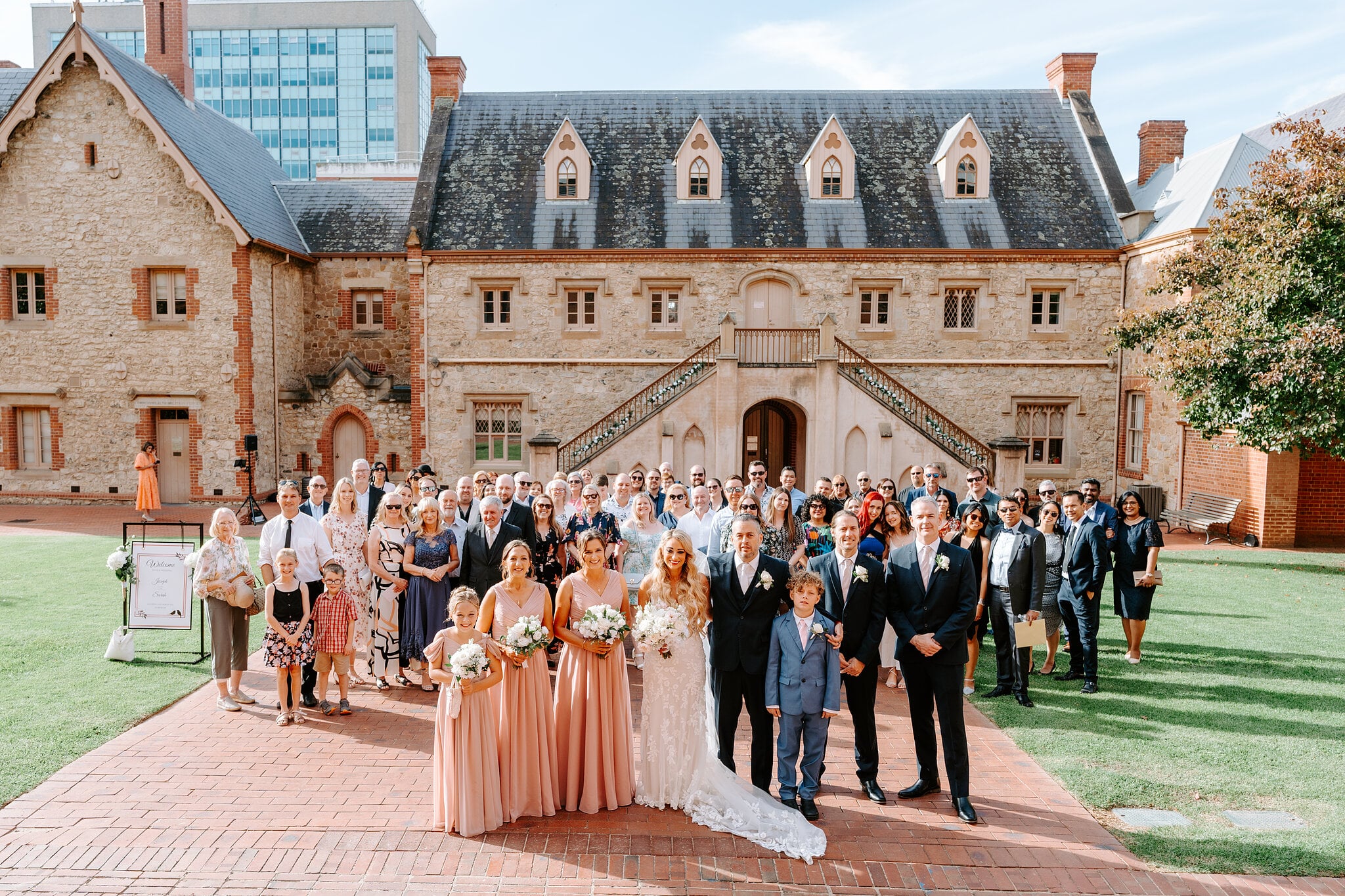 Sarah, Joe and all their guests gather in front of the Armoury for a group photo.