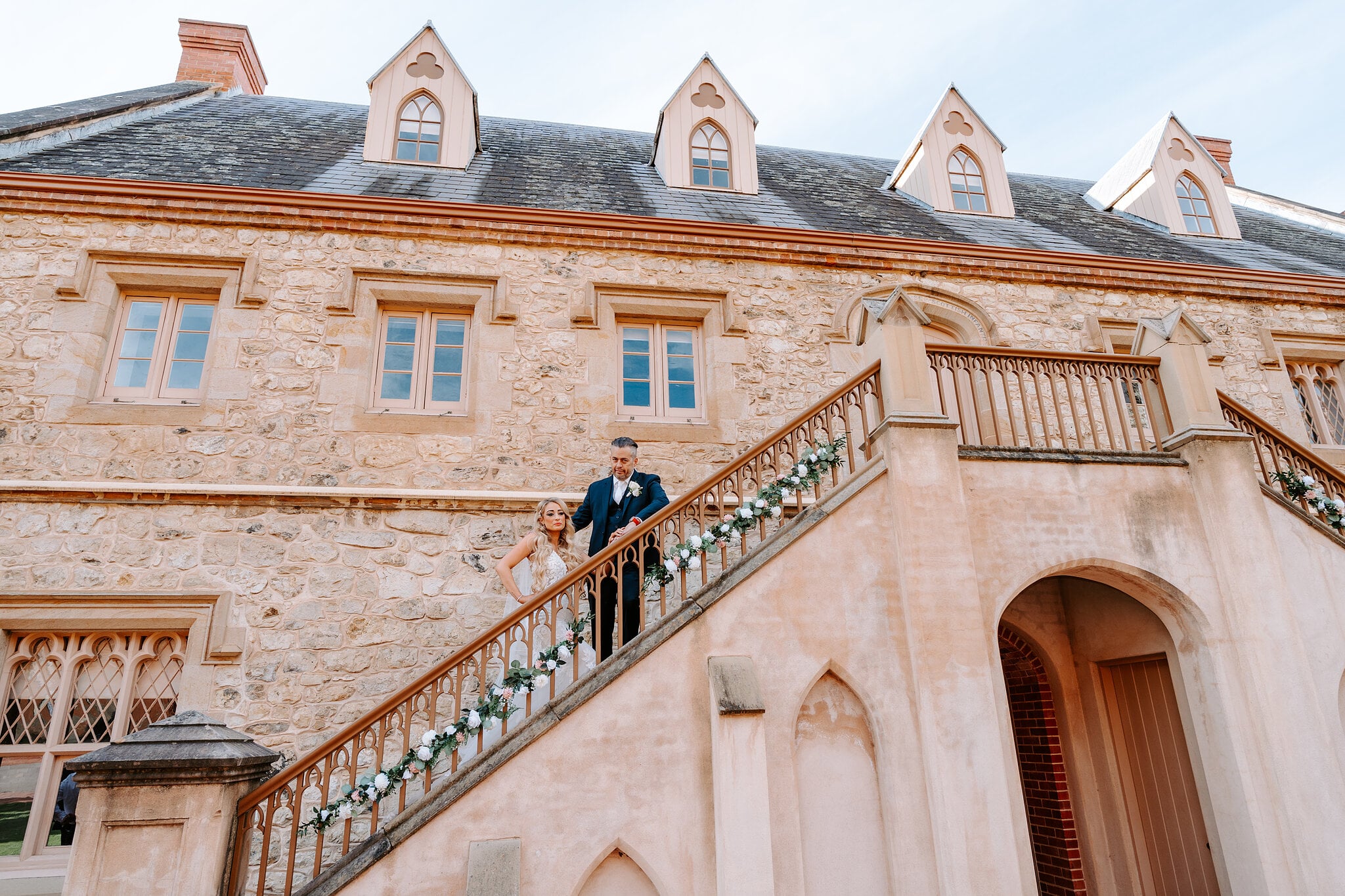 Sarah and Joe look down from the top of the Armoury’s twin staircase.